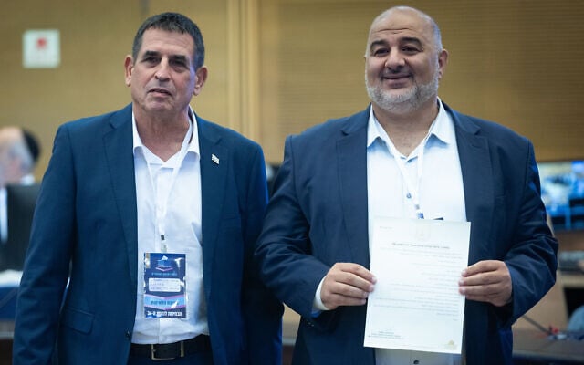Ra’am party chairman Mansour Abbas (left), together with party member Yoav Segalovitz, arrives to submit the party list to the Central Elections Committee ahead of the upcoming Israeli election at the Knesset, in Jerusalem, September 7, 2026. (Yonatan Sindel/Flash90)