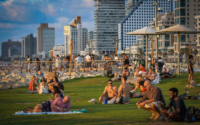 People enjoy a day at the beach in Tel Aviv on the first day of the Jewish holiday of Rosh Hashanah, September 12, 2026. (Avshalom Sassoni/Flash90)