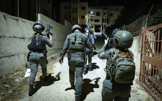 Border Police officers from the Jerusalem Envelope unit raid the Palestinian village of Bir Nabala, near Ramallah, during an early morning counterterrorism operation to arrest suspects, September 15, 2026. (Chaim Goldberg/Flash90)