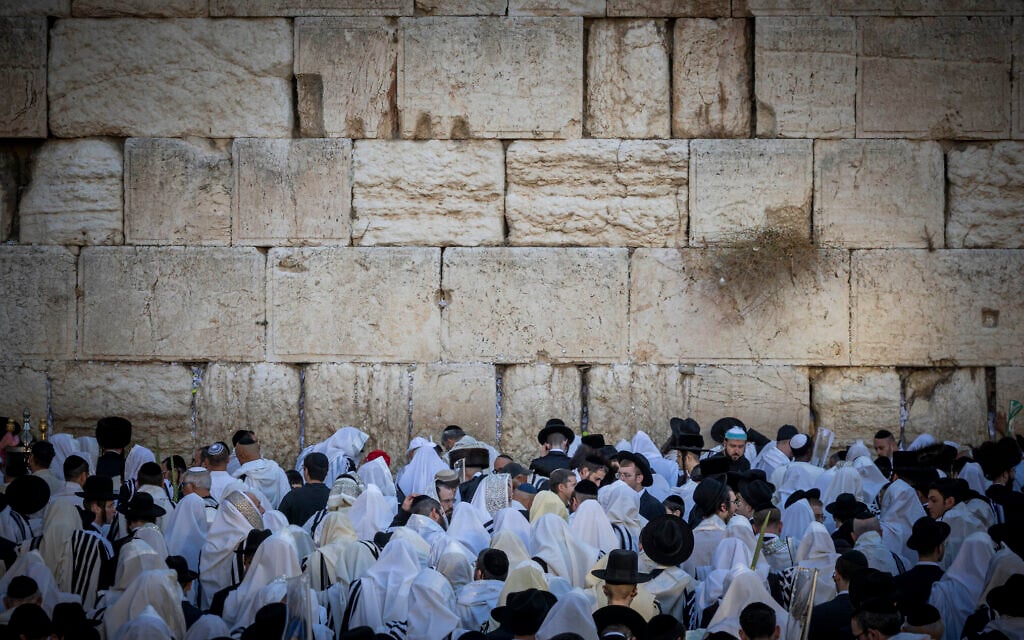 Jewish men covered in prayer shawls take part in morning prayers during the Jewish holiday of Sukkot at the Western Wall in Jerusalem’s Old City, September 28, 2026. (Chaim Goldberg/Flash90) Jewish men covered in prayer shawls take part in morning prayers during the Jewish holiday of Sukkot at the Western Wall in Jerusalem’s Old City, September 28, 2026. (Chaim Goldberg/Flash90)
