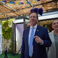 President Isaac Herzog and his wife Michal Herzog welcome members of the Israeli public to the President’s Residence sukkah in Jerusalem during the Jewish holiday of Sukkot, September 29, 2026. (Yonatan Sindel/Flash90)