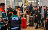 Passengers from flydubai flight FZ1073 walk with their family members through the arrivals hall at Ben Gurion International Airport near Tel Aviv, after their original flight from Dubai to Israel was diverted to Saudi Arabia following an attack on the pilot by his copilot, September 30, 2026. (Avshalom Sassoni/Flash90)