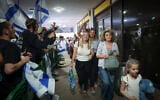 Passengers from flydubai flight FZ1073 walk with their family members after they were saved from an alleged attempt to crash their plane, at Ben Gurion Airport, September 30, 2026. (Jamal Awad/Flash90)