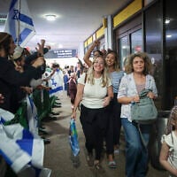 Passengers from flydubai flight FZ1073 walk with their family members after they were saved from an alleged attempt to crash their plane, at Ben Gurion Airport, September 30, 2026. (Jamal Awad/Flash90)