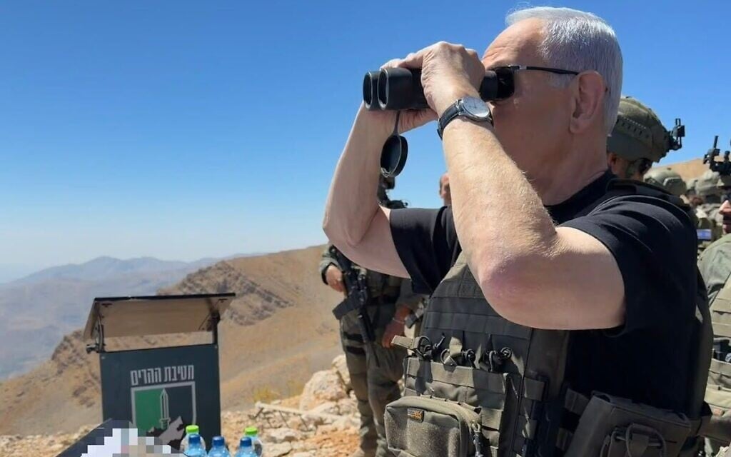 Prime Minister Benjamin Netanyahu peers through binoculars on Mt. Hermon on the Syrian side of the border with Israel, September 9, 2026. (Prime Minister's Office) Prime Minister Benjamin Netanyahu peers through binoculars on Mt. Hermon on the Syrian side of the border with Israel, September 9, 2026. (Prime Minister's Office)