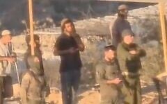 IDF soldiers are filmed praying with settlers at an illegal outpost used to lay siege to Palestinians in the village of Qusra on. August 10, 2026. (Screen capture/X)