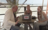 Ongehoord Nederland's then-Editor-in-Chief Joost Niemoller, left, watches a speech by Adolf Hitler, alongside host Arlette Adriani, center, and pundit Raisa Blommenstijn in a segment published by the right-wing Dutch network on July 31, 2026. (Screenshot: Ongehoord Nederland via X)