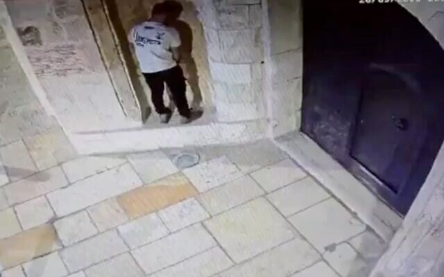 A Jewish man apparently attempts to urinate on the outer wall of the St. James Monastery in the Armenian Quarter of Jerusalem's Old City on September 28, 2026. (Screen capture/X)