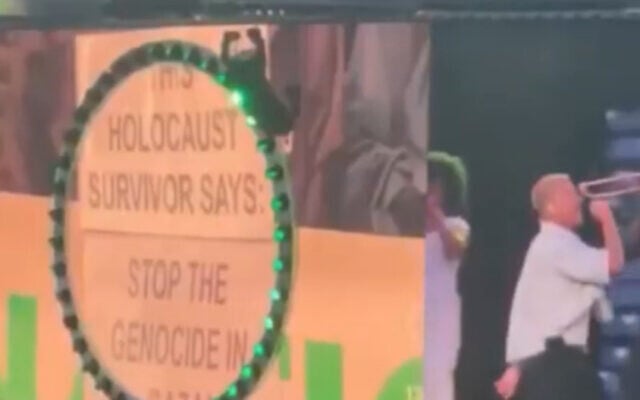 Macklemore performs at MetLife Stadium in East Rutherford, New Jersey, September 5, 2026, as a screen behind him displays a message reading, “Holocaust survivor says stop the genocide in Gaza.” (Screenshot/X)
