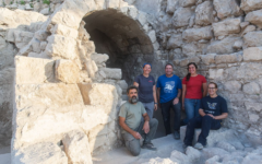 Members of the excavation team, including Uzi Leibner (center), in front of the vaulted ritual bath discovered in excavations at the foot of the Temple Mount in Jerusalem (Aubrey Mercado)