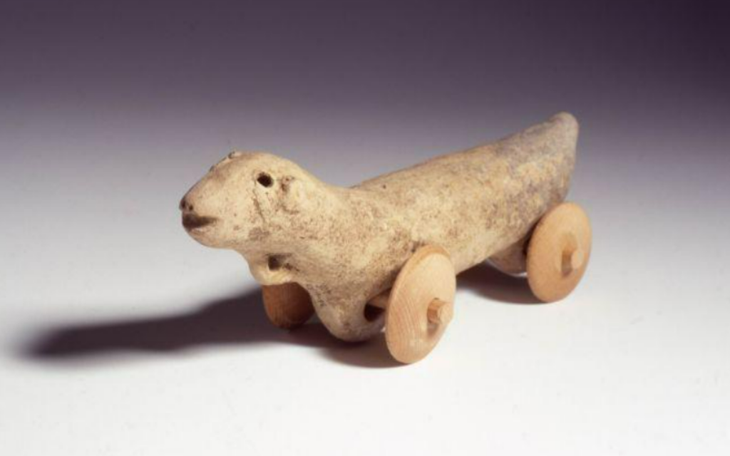 An otter-shaped pull toy from the 11th century BCE, pottery. The wooden wheels are modern. (Avraham Hay/Israel Museum)