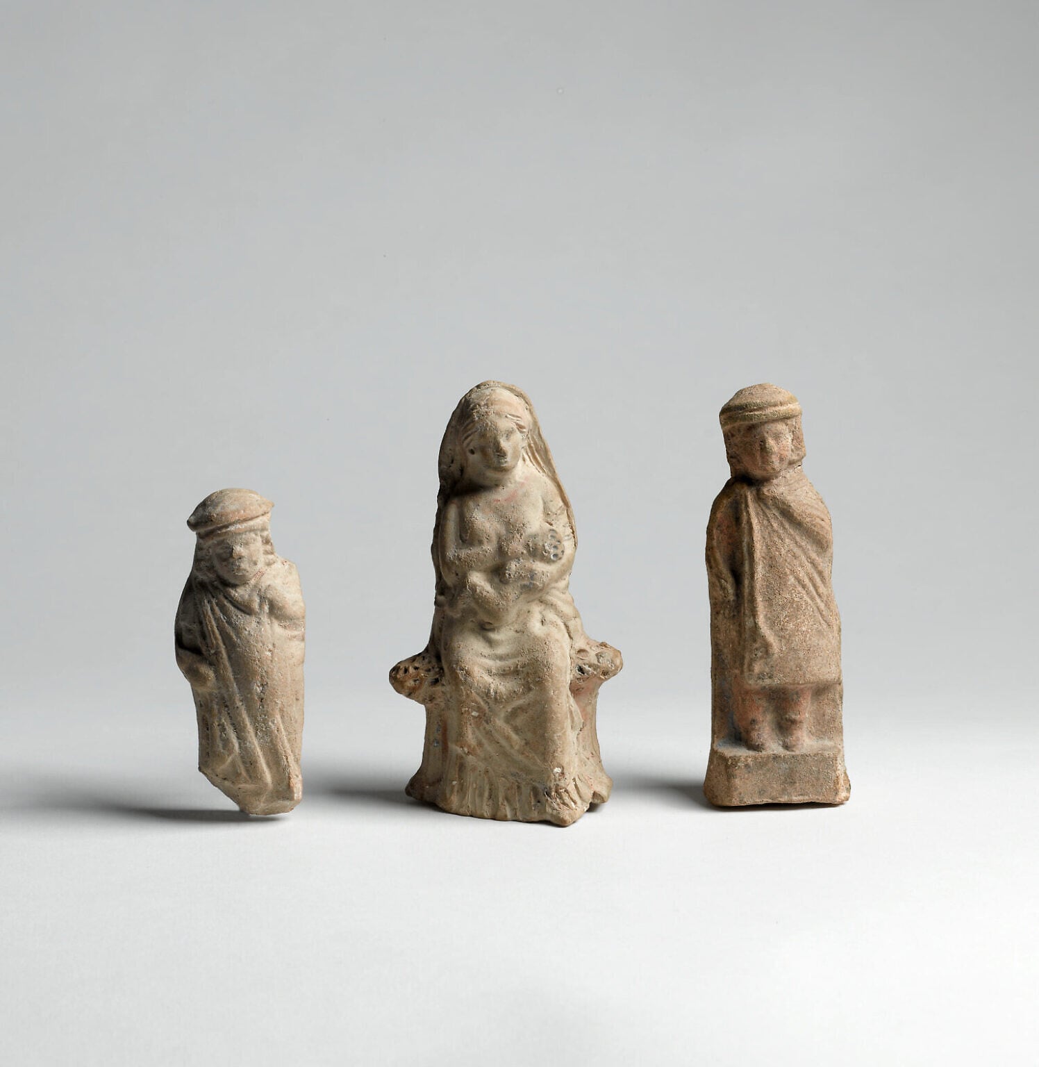 Hellenistic figurines depicting a child, a woman suckling an infant, and a youth. Courtesy of the Israel Antiquities Authority (Meidad Suchowolski/Israel Museum)