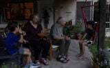 Aviva Siegel, 65, and her husband Keith Siegel, 67, both former hostages, chat with two of their grandchildren at their home in Kibbutz Gazit, northern Israel, August 6, 2026. (Shir Torem/Reuters)