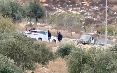 Vehicles at the site where Belgium's foreign minister says masked settlers attacked Western diplomats and officials near Taybeh, in the West Bank, on October 17, 2026. (Emad Diab/via REUTERS)