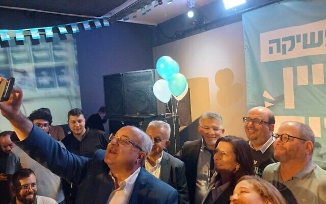 MK Ahmad Tibi holds up a camera as he takes a selfie with fellow leaders of the Joint List during the Arab-majority party's Hebrew-language campaign launch in Tel Aviv on October 5, 2026. (Noam Lehmann/The Times of Israel) MK Ahmad Tibi holds up a camera as he takes a selfie with fellow leaders of the Joint List during the Arab-majority party's Hebrew-language campaign launch in Tel Aviv on October 5, 2026. (Noam Lehmann/The Times of Israel)