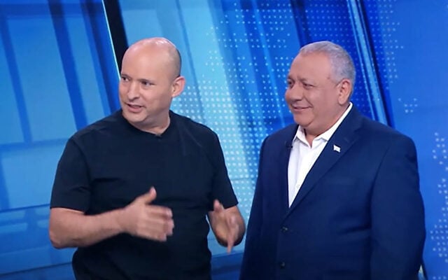 Opposition party leaders Naftali Bennett of B'Yachad (left) and Gadi Eisenkot of Yashar (right) cross paths in the Channel 12 News on October 24, 2026, three days before elections. (Channel 12 Screenshot) Opposition party leaders Naftali Bennett of B'Yachad (left) and Gadi Eisenkot of Yashar (right) cross paths in the Channel 12 News on October 24, 2026, three days before elections. (Channel 12 Screenshot)