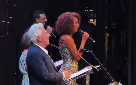 Dustin Hoffman (left) joins Israeli singer Ester Rada for Israel’s national anthem, “Hatikvah,” at a special evening of solidarity with Israel at UCLA in Los Angeles, October 21, 2026. (Screenshot/ 
@erevtov2/Israelim via X)