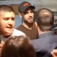A screenshot of video showing Mordechai David and other right-wing protesters clashing with people at the Joint List's campaign headquarters in Tel Aviv, October 15, 2026. (X screenshot)
