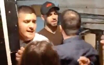 A screenshot of video showing Mordechai David and other right-wing protesters clashing with people at the Joint List's campaign headquarters in Tel Aviv, October 15, 2026. (X screenshot)