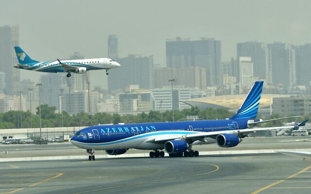 A picture take on September 14, 2017, shows a Oman air plane landing at the tarmac at Dubai’s International Airport. (Giuseppe Cacace/AFP)