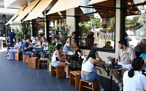 People eat at a restaurant in downtown Beirut on August 2, 2024. (JOSEPH EID/ AFP/ File)
