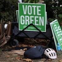 Campaigners for Britain’s leader of the Green Party, Zack Polanski, prepare signs before his arrival in London on September 12, 2026. (Toby Shepheard/ AFP)