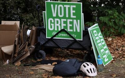 Campaigners for Britain’s leader of the Green Party, Zack Polanski, prepare signs before his arrival in London on September 12, 2026. (Toby Shepheard/ AFP)