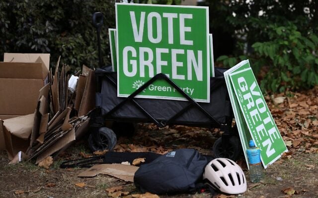 Campaigners for Britain’s leader of the Green Party, Zack Polanski, prepare signs before his arrival in London on September 12, 2026. (Toby Shepheard/ AFP)