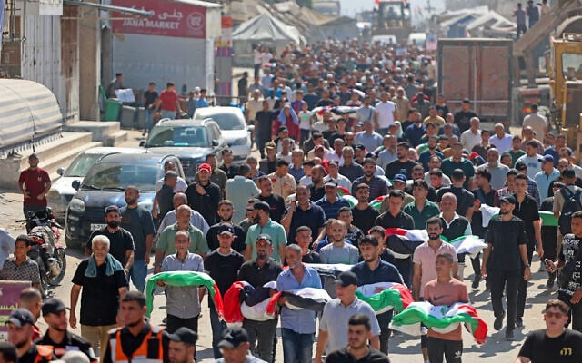 Palestinian mourners attend a mass funeral procession in Gaza’s al-Yarmouk neighborhood on October 1, 2026, following the recovery of 105 bodies from beneath the rubble of the al-Taj residential block which was destroyed by Israeli strikes three years ago. (Omar Al-Qattaa/AFP)