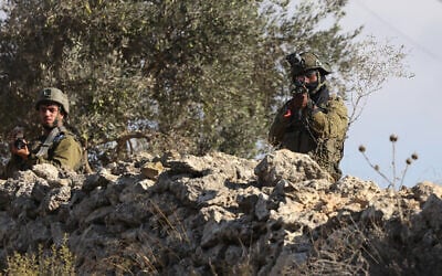 An IDF soldier aims his rifle during a reported attack by settlers on Palestinians picking olives in the village of Beita, south of Nablus, in the West Bank on October 2, 2026. (JAAFAR ASHTIYEH/AFP) An IDF soldier aims his rifle during a reported attack by settlers on Palestinians picking olives in the village of Beita, south of Nablus, in the West Bank on October 2, 2026. (JAAFAR ASHTIYEH/AFP)