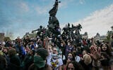 People gather on and around the statue in the center of the Place de la Republic square at the end of a demonstration part of a nationwide day of actions called by high-school students, joined by unions and teachers, who for days have been demanding better learning conditions in protests punctuated by violent confrontations in Paris on October 6, 2026. (Dimitar DILKOFF/AFP)