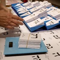 A worker weighs newly printed ballot papers, at a printing factory, ahead of the October 27 Israeli legislative election in Kiryat Gat, southern Israel, on October 8, 2026. (Jack Guez/AFP))