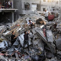 People search the rubble of a collapsed building following overnight Israeli airstrikes in Gaza City on October 9, 2026, before which the Israeli military had warned residents to evacuate the area. (Omar AL-QATTAA/AFP)
