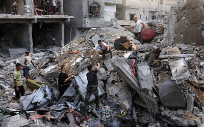 People search the rubble of a collapsed building following overnight Israeli airstrikes in Gaza City on October 9, 2026, before which the Israeli military had warned residents to evacuate the area. (Omar AL-QATTAA/AFP)