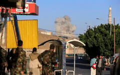 A plume of smoke rises during a reported airstrike by the Saudi-led coalition on the Houthi-controlled Yemeni capital Sanaa, on October 9, 2026. (AFP)