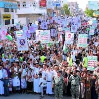Supporters of the Houthi authorities hold placards and shout slogans as they protest against the Saudi intervention in Yemen, in the city of Hodeida on October 9, 2026. (Zayed Al-Waqidi/AFP)