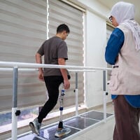 Zuhdi Abou Shanab, a 17-year-old Palestinian boy who lost his entire right leg below the hip during the war in Gaza, undergoes rehabilitation treatment with his prosthetic at a medical center in Amman on October 13, 2026 as part of the 'Jordanian medical corridor' initiative. (George SAIF/AFP)