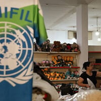 A worker arranges merchandise made for personnel of the United Nations Interim Force in Lebanon (UNIFIL) at a factory showroom in Lebanon’s southern border village of Ibl al-Saqi on October 13, 2026. (Joseph EID/AFP)