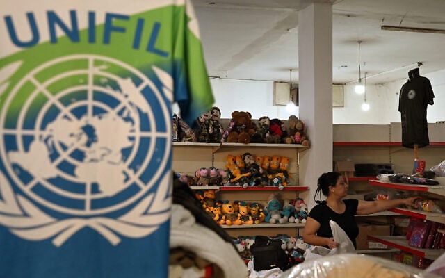 A worker arranges merchandise made for personnel of the United Nations Interim Force in Lebanon (UNIFIL) at a factory showroom in Lebanon’s southern border village of Ibl al-Saqi on October 13, 2026. (Joseph EID/AFP)