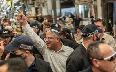 National Security Minister Itamar Ben Gvir, center, tours the market in Ramle on October 14, 2026. (Ilia YEFIMOVICH/AFP)