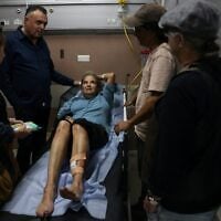 American photojournalist Heidi Levine lies on a gurney in the emergency room of the government hospital in the city of Ramallah, as she is treated after being attacked by Israeli settlers while photographing Palestinian farmers harvesting their olives in the Palestinian village of Abu Falah on October 16, 2026. (AHMAD GHARABLI/AFP)