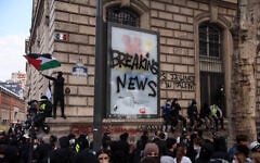 A protester waves a Palestinian flag as he gathers with others to demonstrate against the “high cost of living,” in Paris on October 17, 2026, amid nationwide unrest in France. (Kiran Ridley/AFP)