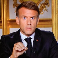 This photograph shows a television monitor broadcasting France’s President Emmanuel Macron giving a speech from the Elysee Presidential Palace the day after riots and looting on the sidelines of nationwide protests over the cost of living, in Paris, France, on October 18, 2026. (Ludovic MARIN/AFP)