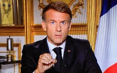 This photograph shows a television monitor broadcasting France’s President Emmanuel Macron giving a speech from the Elysee Presidential Palace the day after riots and looting on the sidelines of nationwide protests over the cost of living, in Paris, France, on October 18, 2026. (Ludovic MARIN/AFP)