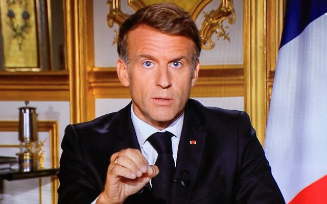 This photograph shows a television monitor broadcasting France’s President Emmanuel Macron giving a speech from the Elysee Presidential Palace the day after riots and looting on the sidelines of nationwide protests over the cost of living, in Paris, France, on October 18, 2026. (Ludovic MARIN/AFP) This photograph shows a television monitor broadcasting France’s President Emmanuel Macron giving a speech from the Elysee Presidential Palace the day after riots and looting on the sidelines of nationwide protests over the cost of living, in Paris, France, on October 18, 2026. (Ludovic MARIN/AFP)