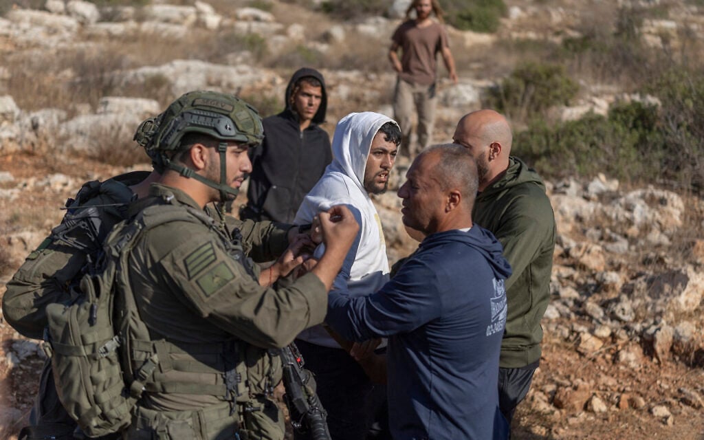 A Palestinian man is arrested by Israeli soldiers during the olive harvest in West Bank village of Deir Abu Mashal on October 19, 2026. (ilia YEFIMOVICH/AFP) A Palestinian man is arrested by Israeli soldiers during the olive harvest in West Bank village of Deir Abu Mashal on October 19, 2026. (ilia YEFIMOVICH/AFP)