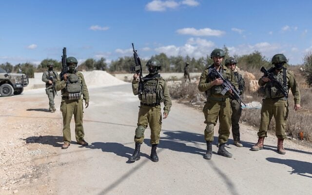 IDF soldiers gather on a road close to an olive grove following a reported attack by Israeli settlers on a Palestinian home in the West Bank village of Turmus Ayya on October 19, 2026. (ilia YEFIMOVICH/AFP) IDF soldiers gather on a road close to an olive grove following a reported attack by Israeli settlers on a Palestinian home in the West Bank village of Turmus Ayya on October 19, 2026. (ilia YEFIMOVICH/AFP)