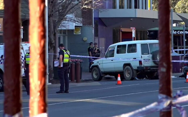 This frame grab taken from video footage provided by the Australian Broadcasting Corporation (ABC) on October 19, 2026 via AFPTV shows police officers at the scene after Australian independent lawmaker Helen Haines was struck by a car and suffered critical injuries outside her office in Wangaratta, about 200 kilometers northeast of Melbourne. (AFP/AUSTRALIAN BROADCASTING CORPORATION)