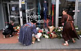 People lay flowers outside the office of Australian politician Helen Haines in the northern regional city of Wangaratta, some 250 kilometers north-east of Melbourne on October 20, 2026. (William West/AFP)