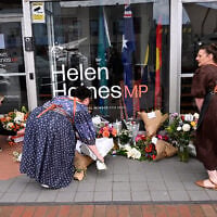 People lay flowers outside the office of Australian politician Helen Haines in the northern regional city of Wangaratta, some 250 kilometers north-east of Melbourne on October 20, 2026. (William West/AFP)
